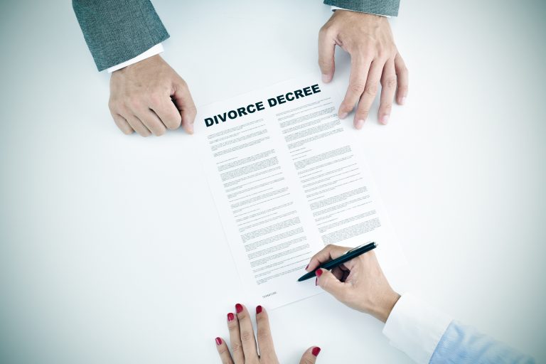 High-angle,Shot,Of,A,Young,Woman,Signing,A,Divorce,Decree Law News | Leading Law Firm Analyses “No-Fault Divorce”, Terms It Beneficial For Divorcing Families