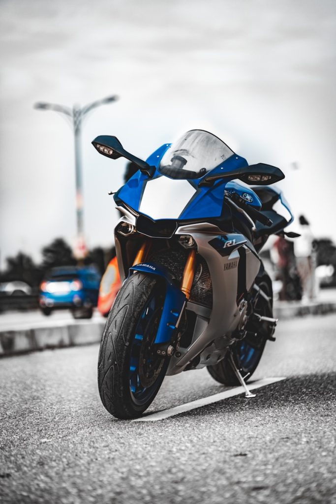 Photo by Zac Wolff orange and black sports bike on road during daytime