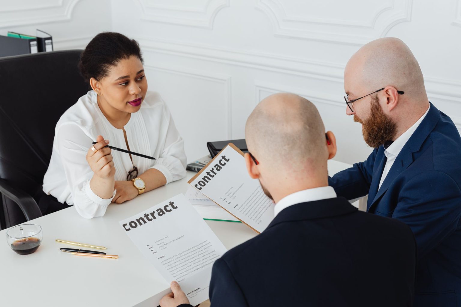 Business professionals reviewing a contract in a modern office