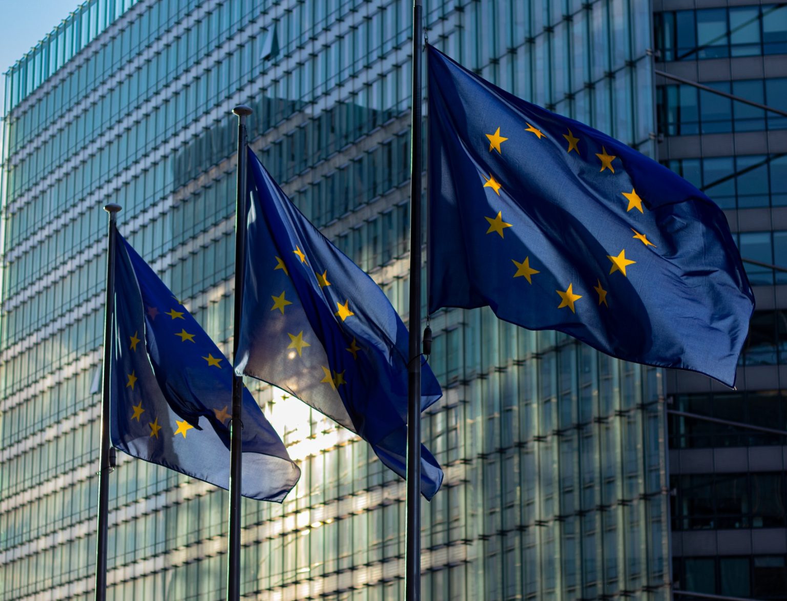 benefits-of-global-expansion-for-domestic-businesses-entering-european European Union flags flying outside a glass office building in Brussels