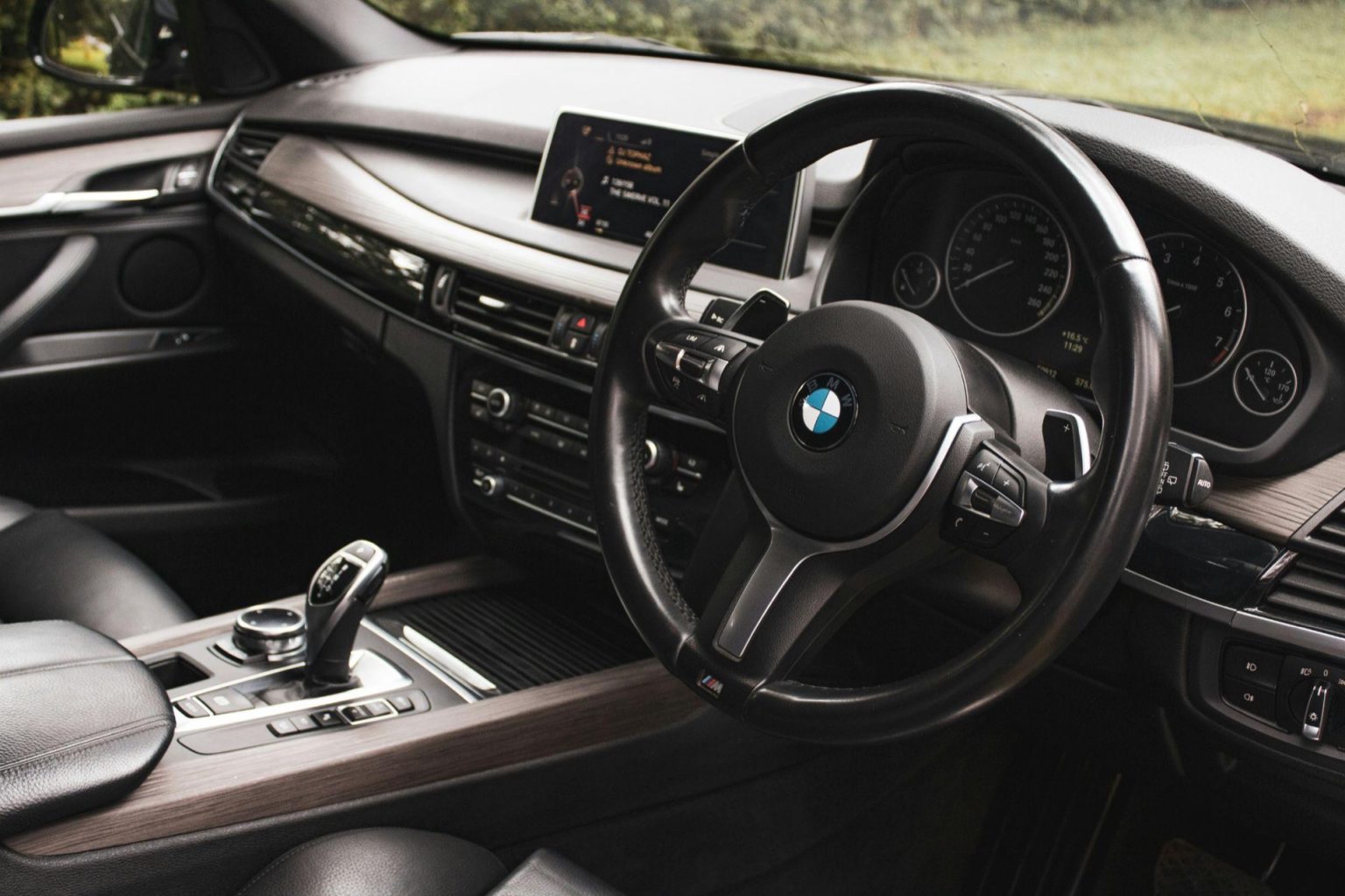 BMW interior with sports steering wheel, gear selector and centre console
