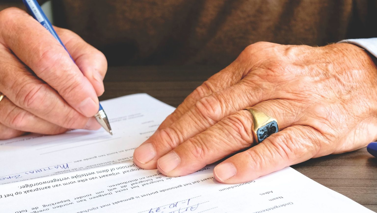 Contentious probate and contesting a will Senior person signing a will document