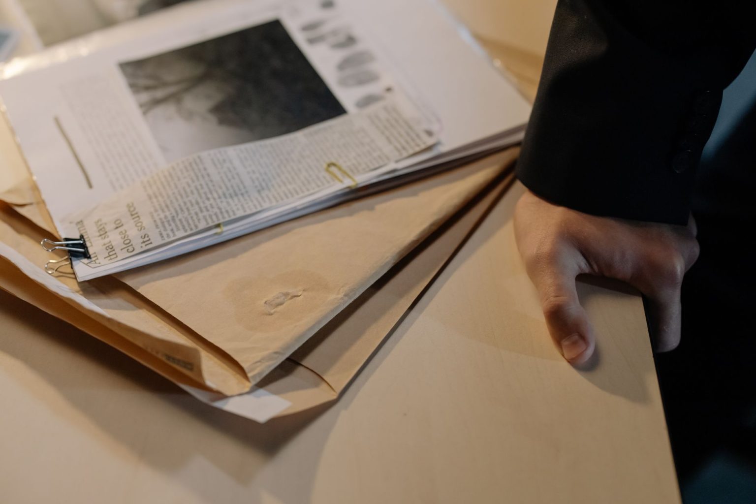 how-criminal-cases-are-investigated-beyond-the-police-file Case files and newspaper clippings on a desk during a criminal investigation