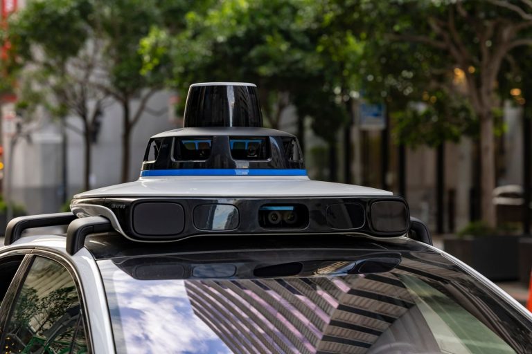 Roof-mounted sensor array on top of an autonomous car in a city street