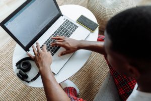 A person typing on a laptop at home