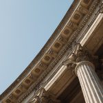 Classical stone columns against a clear sky