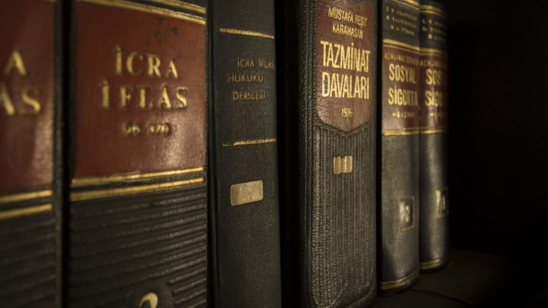 Law and regulation books on a bookshelf
