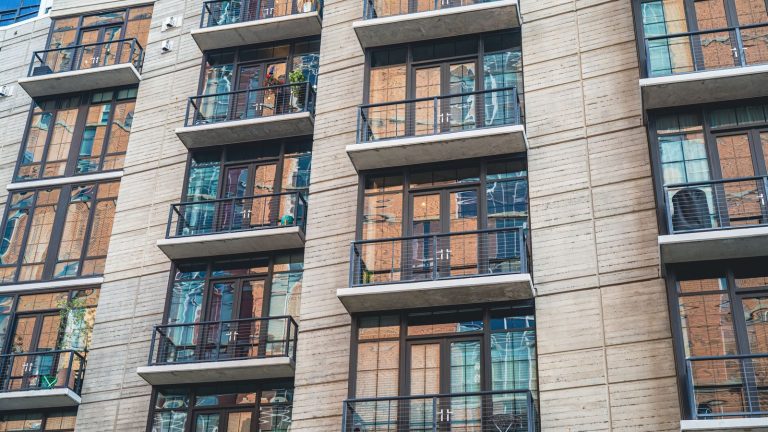 Apartment building with a concrete facade and glass balconies