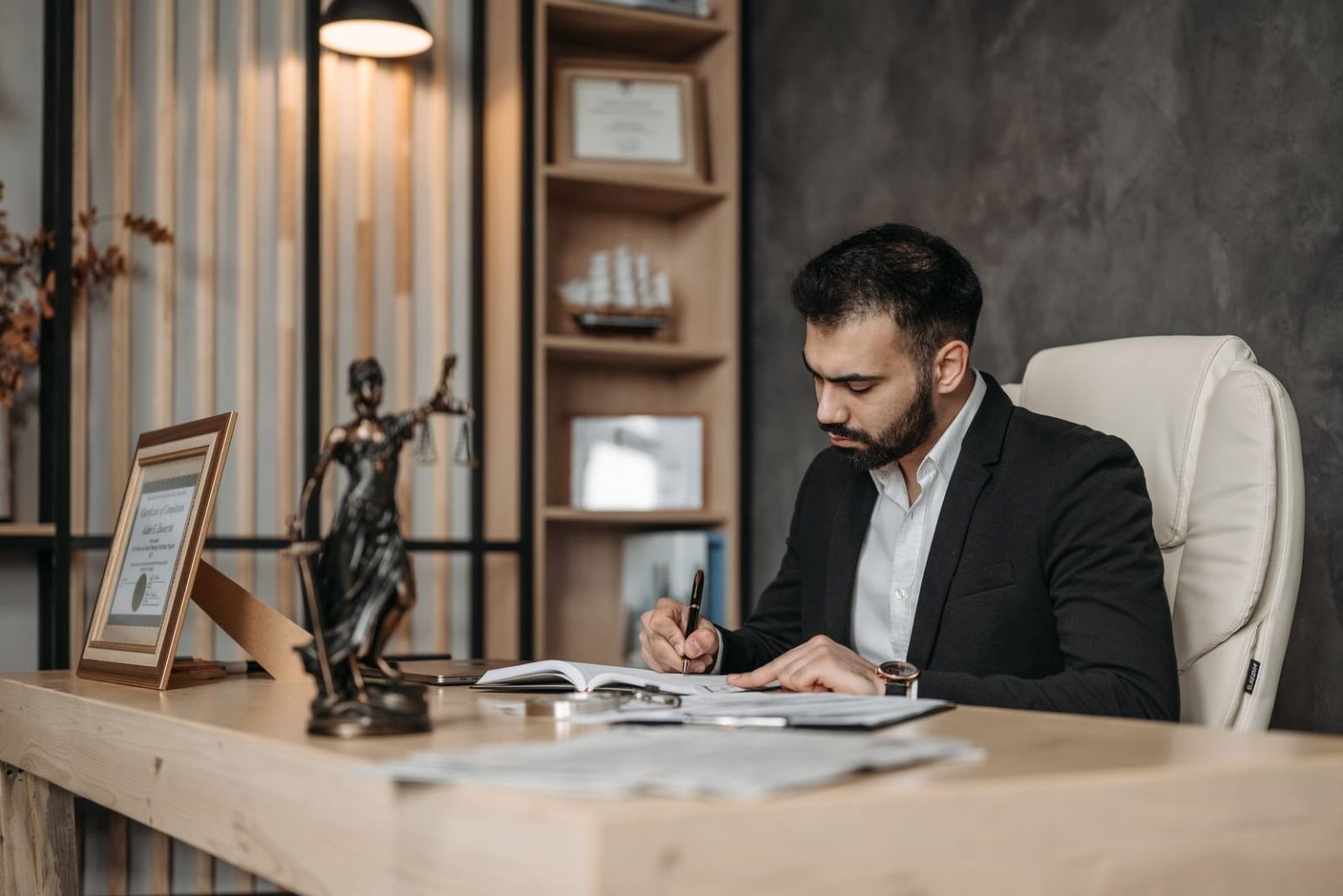 A lawyer reviewing documents at a desk in an office