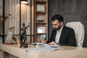A lawyer reviewing documents at a desk in an office