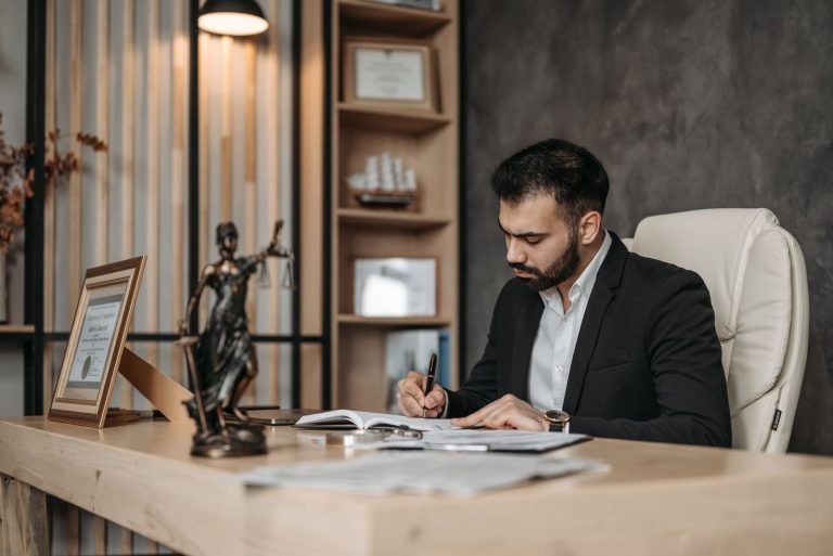 A lawyer reviewing documents at a desk in an office
